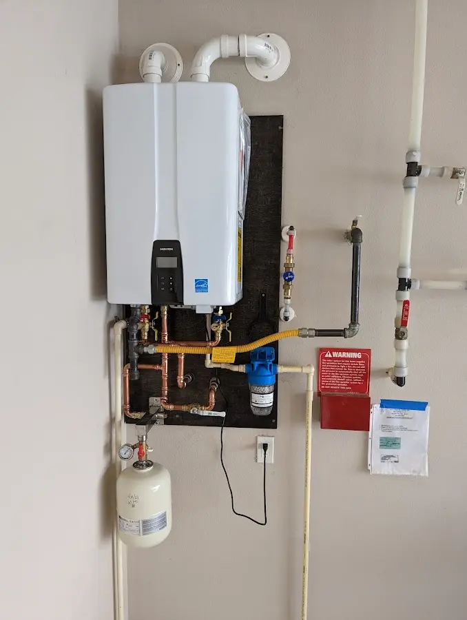Professional plumber installing copper piping in a Westerly home